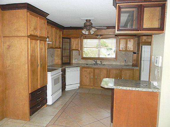 Just replaced the granite & tile backsplash. Note the designer cabinets with glass doors & 2-tone highlights.