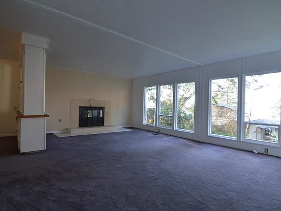Marble surround/hearth in LR w/ water views.