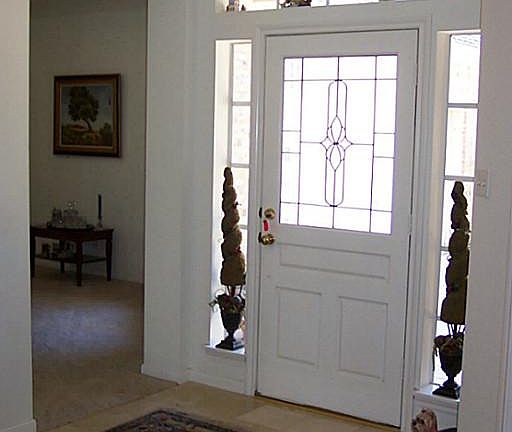 Warm and inviting front entry with marble flooring