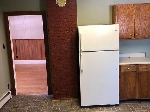 Kitchen looking into living room. Pantry is to the right of the cabinets. No fridge included with apt.