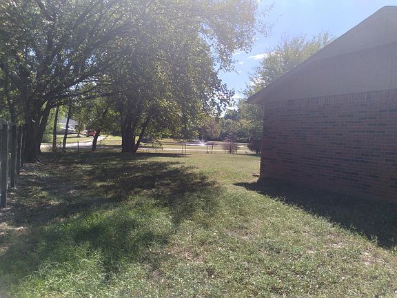 side view. Check out back yard. There's a beautiful private park behind the fence. A pond with a water a water fountain makes a great view.