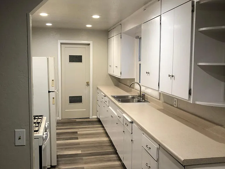 Kitchen leading to laundry room with new inset lights