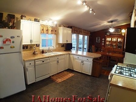 Kitchen - Tile floors, large baseboards, white porcelain sink, new counter top, newer gas stove and refrigerator included.