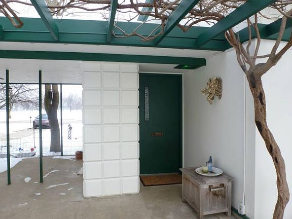 Beautiful main entry surrounded by a wisteria-covered pergola!  The wisteria is believed to have been planted back in the 1930's!