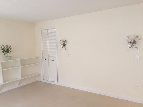 Light, bright living room with 2 closets, cozy fireplace, bookshelving, laminate flooring and more!