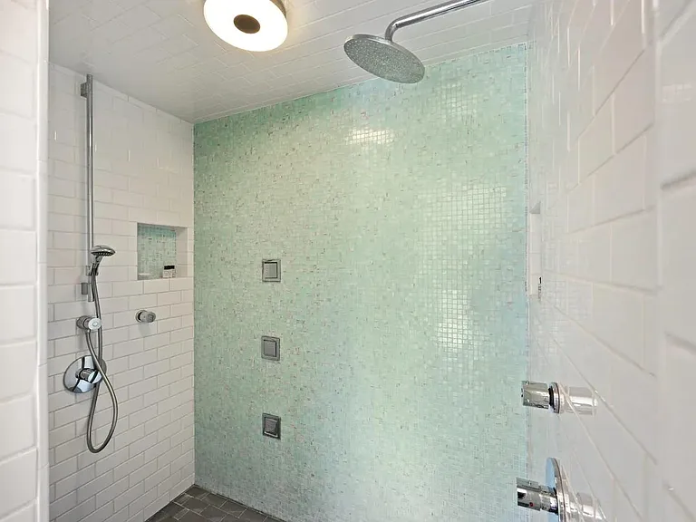 Refresh in our modern, stylish showers with dual Hansgrohe fixtures and premium Kohler Water Tile body sprays.