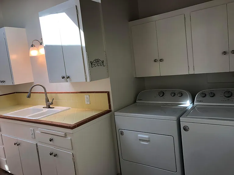 Kitchen view with the washer and gas dryer.