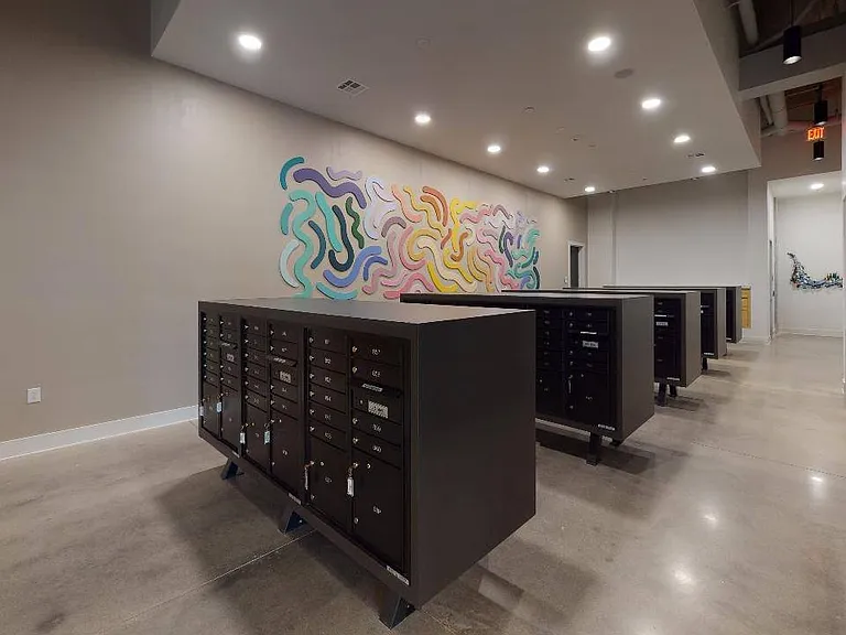 Mail room and dry cleaning lockers at Modera Washington, featuring unique art (you'll find more throughout the community).