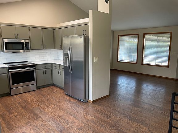 view from dining room looking into kitchen and living room