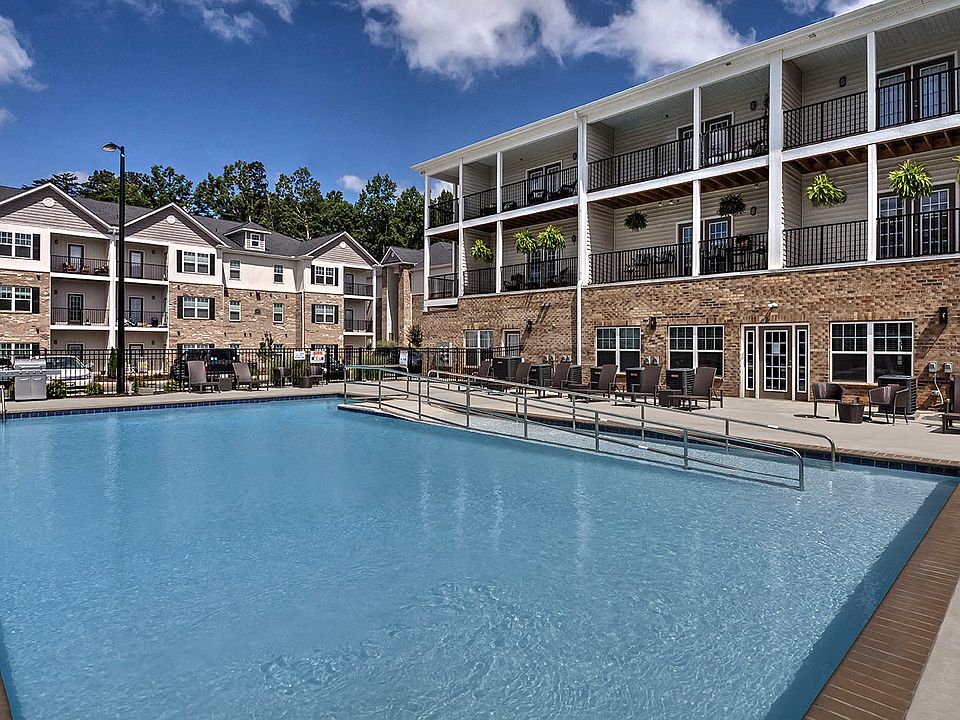 Outdoor pool with lounge chairs at Retreat at the Park apartments for rent in Burlington, NC