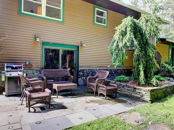Back of the House with Blue Stone Patio, Walled Garden with Weeping Norway Spruce and Stone Path