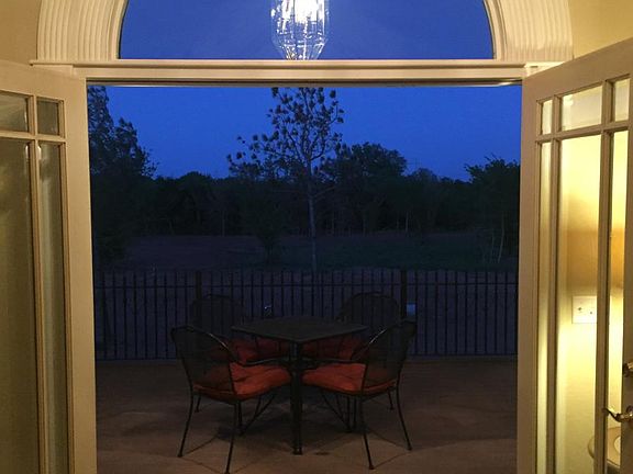 Double doors to 13x20 walk-out balcony off the great room. Evening photo.