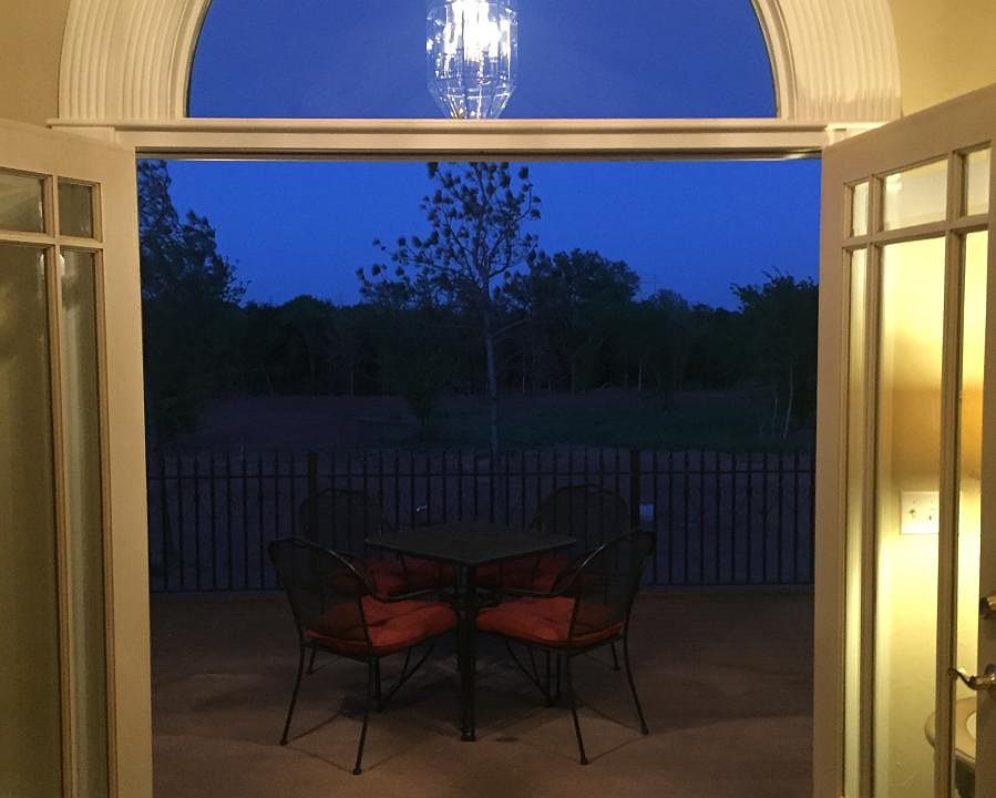Double doors to 13x20 walk-out balcony off the great room. Evening photo.