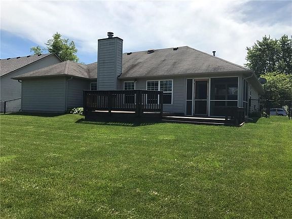 Huge fully-fenced in backyard with a deck and screened-in porch off of the kitchen.