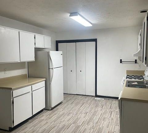 kitchen area with laundry behind the bi fold doors.