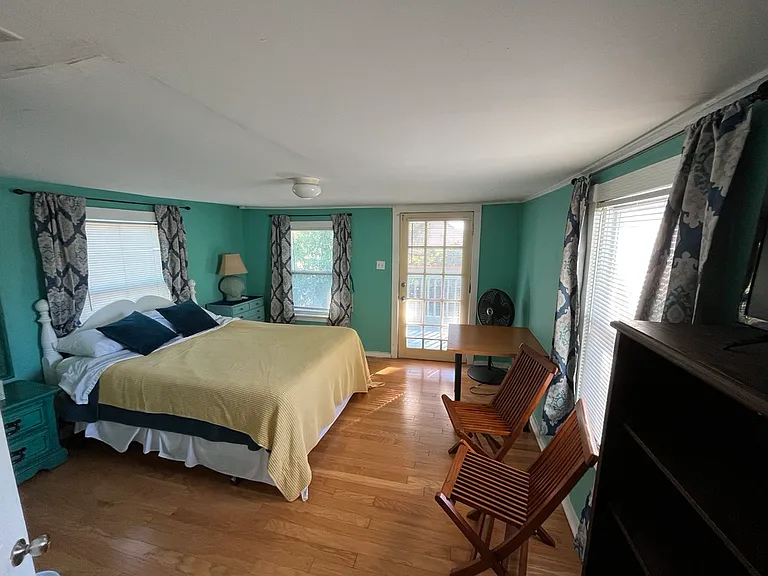 This is the third bedroom. It has a queen bed, bookshelf and small closet. It also has a private exit/entrance to the upstairs back porch facing the yard.