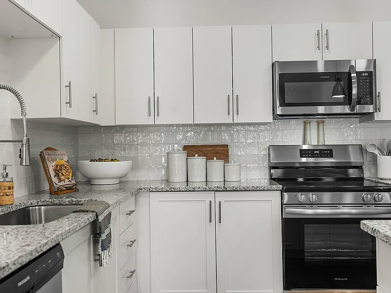 Experience culinary delight in this beautifully designed kitchen, combining style and functionality.