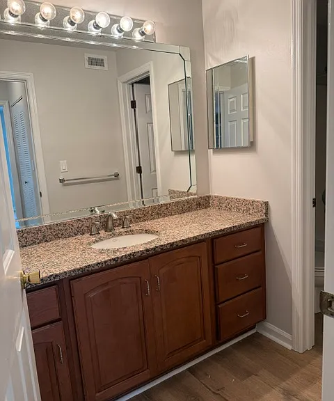 bathroom vanity with granite top and ample storage