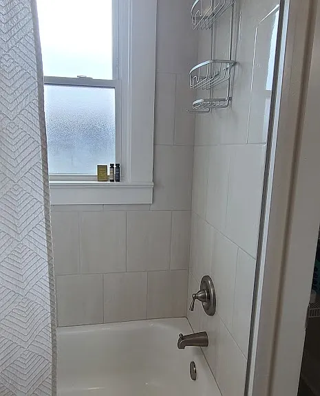Tub/shower combo in bathroom.