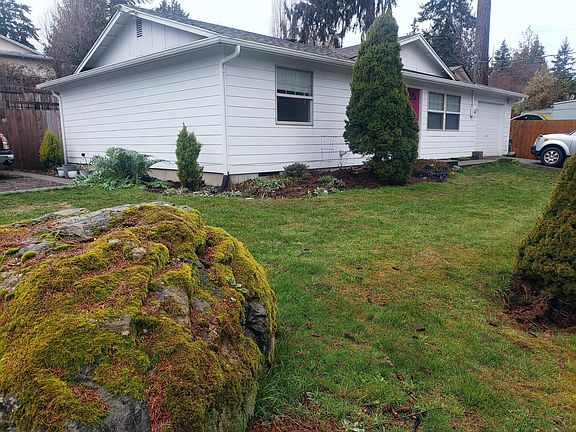 Corner lot, large side parking, and two car parking in front of one car garage.