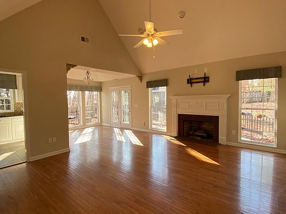 living room with elevated ceiling and hardwood floors throughout