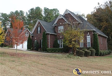 House pictured with detached garage
