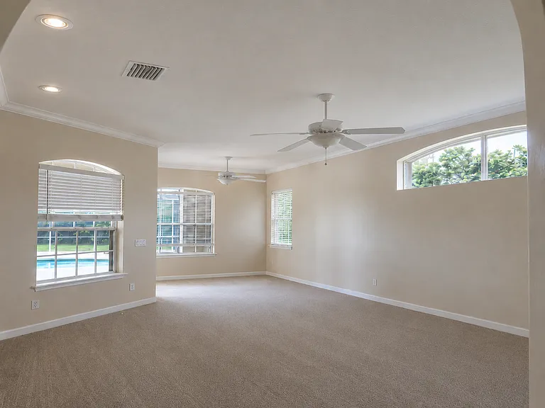 Spacious Primary Suite with Pool Views and Sitting Area