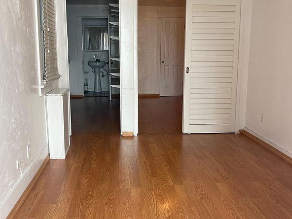 Living room looking toward bedroom on the right at kitchen on the left