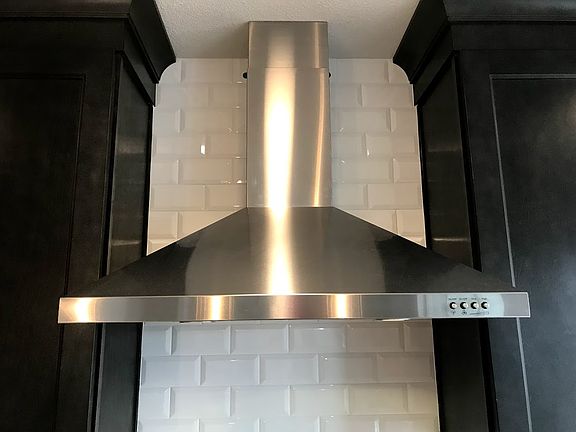 Gas vent hood over the range with designer back splash.