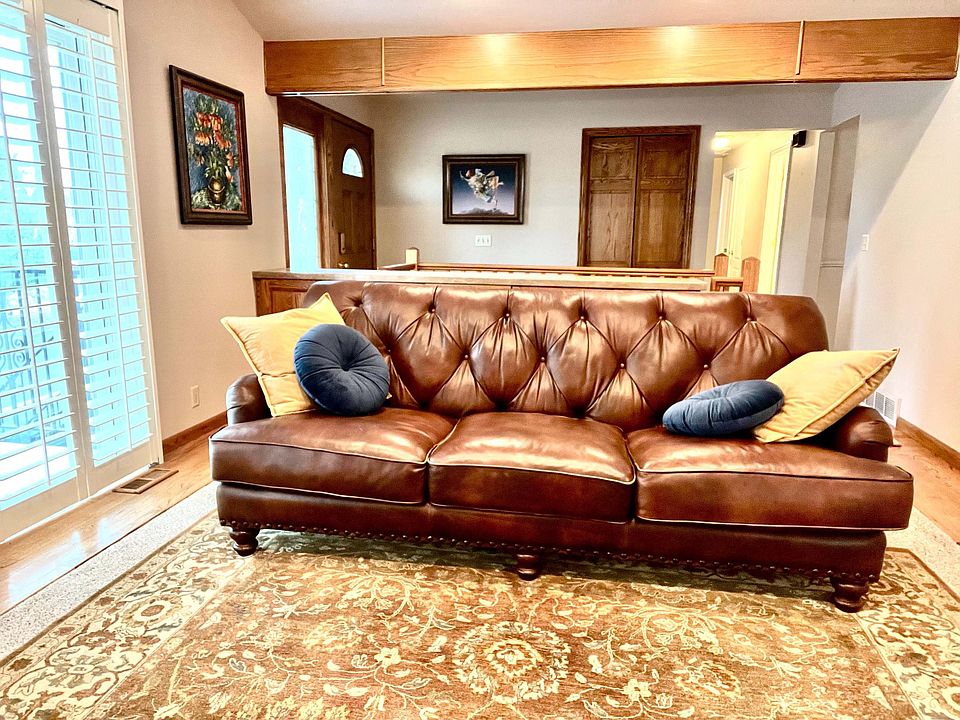 Formal entry living room with vaulted ceilings and balcony