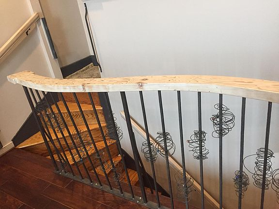 Sculptural railings made from home's original ceiling joists