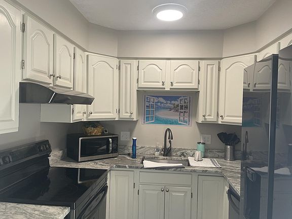 Kitchen with new granite counters and all new appliances. Includes a dishwasher.