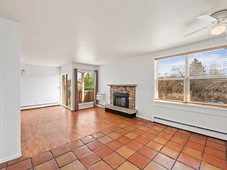 Main floor living area with newer electronic fireplace.