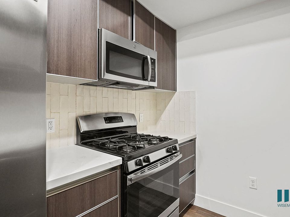 Kitchen with Stainless Refrigerator, Stove, and Microwave Oven