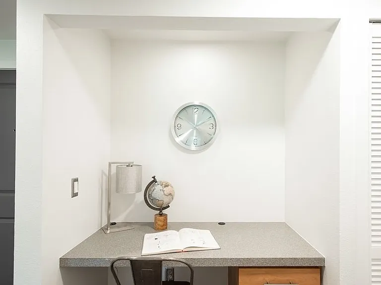 Solid built in desk area with oversized drawers in the hallway- can be used as an extra office or reading nook or for extra storage or decor space