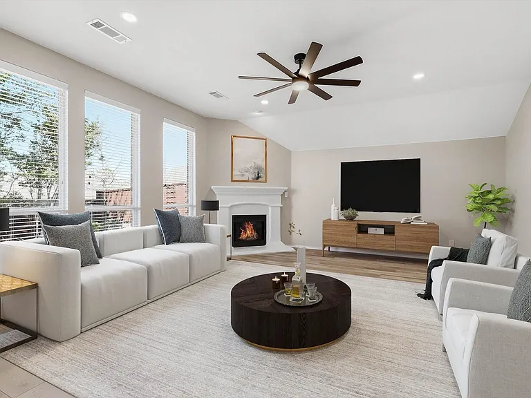 Spacious living area featuring a vaulted ceiling with a ceiling fan, recessed lighting, and large windows with blinds