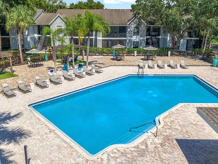 Unwind in style at River Reach's expansive resort-style pool deck, complete with lounge chairs, pergolas, and lush palm trees for that true Florida feel.