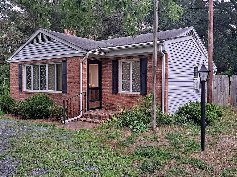 Front of house. Large front yard and driveway off street. Side yards accessing fenced in backyard.