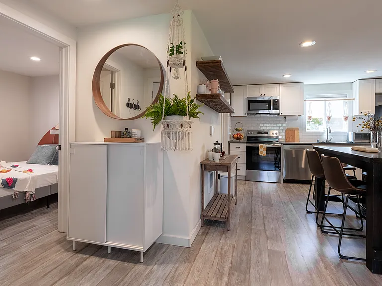Front entrance view into second bedroom on left and dining area to the right