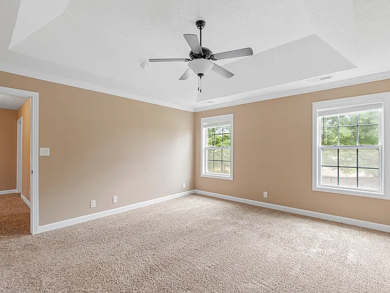 Expansive Master Bedroom with tray ceiling