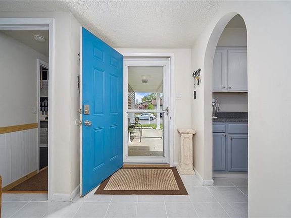 Invent and clean entry way with white tile