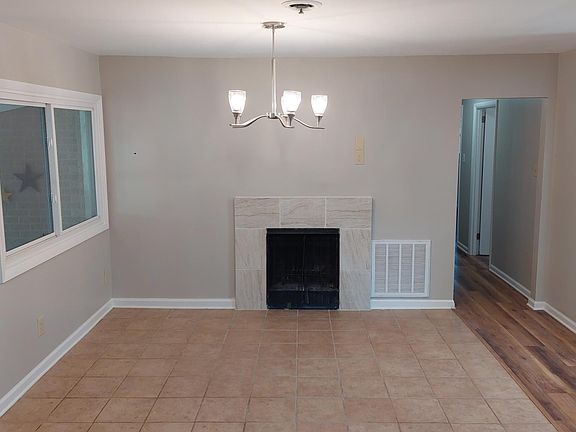 Kitchen opens to large dining area with fireplace.