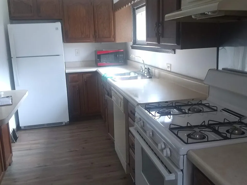 Kitchen with fridge, stove, and dishwasher.