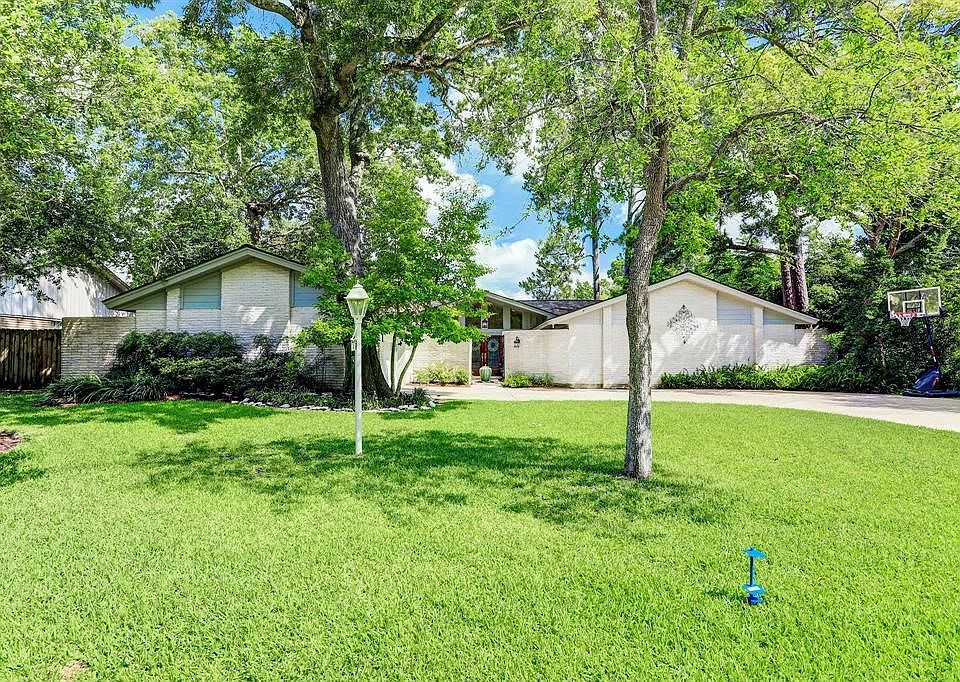 Welcome to 1419 Pirates Cove. This stately home is adorned with native Texas trees and plants. In Nassau Bay you get the best of both worlds with large, wooded lots and access to Clear Lake. Character abounds with the best in custom home building.