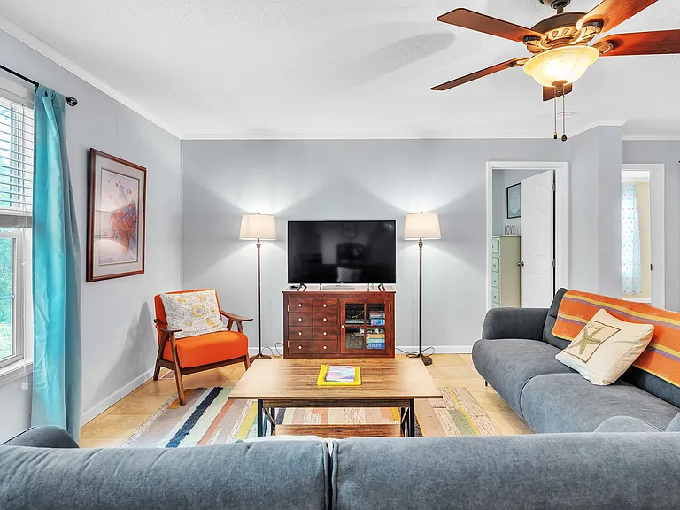 Another view of the living room that seats 7 with additional seating at the high-top table and counter.