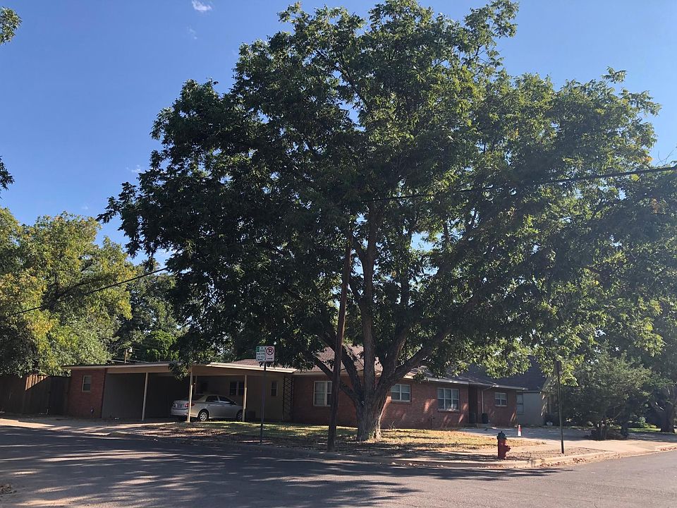 Property is located one block from Texas Tech University and has a front circle drive and 2-car, carport, with mature trees on a corner, double lot.