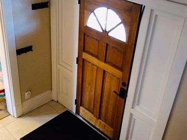 Lovely entrance with updated door, hardware, oversized ceramic tile and coat closet.
