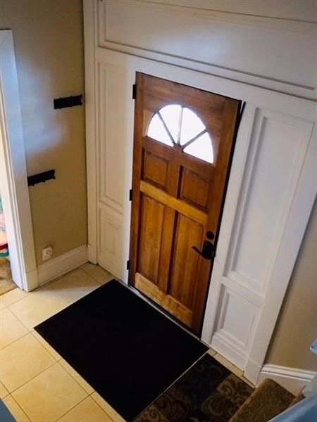 Lovely entrance with updated door, hardware, oversized ceramic tile and coat closet.