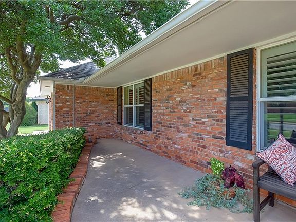 Nice overhang makes the front porch a great spot to watch the neighbors walk, or just hang in the shade. Sprinkler system keeps the yard nice and pretty.