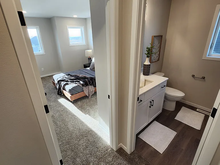 Bedroom three and full upstairs bath. (Pictures are of another unit with similar finishes and features.)